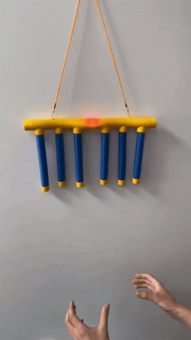 man playing the catching sticks challenge kit